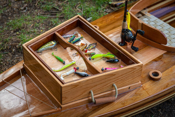 the tackle box of a wooden fishing canoe