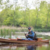 a wooden fishing canoe on the river