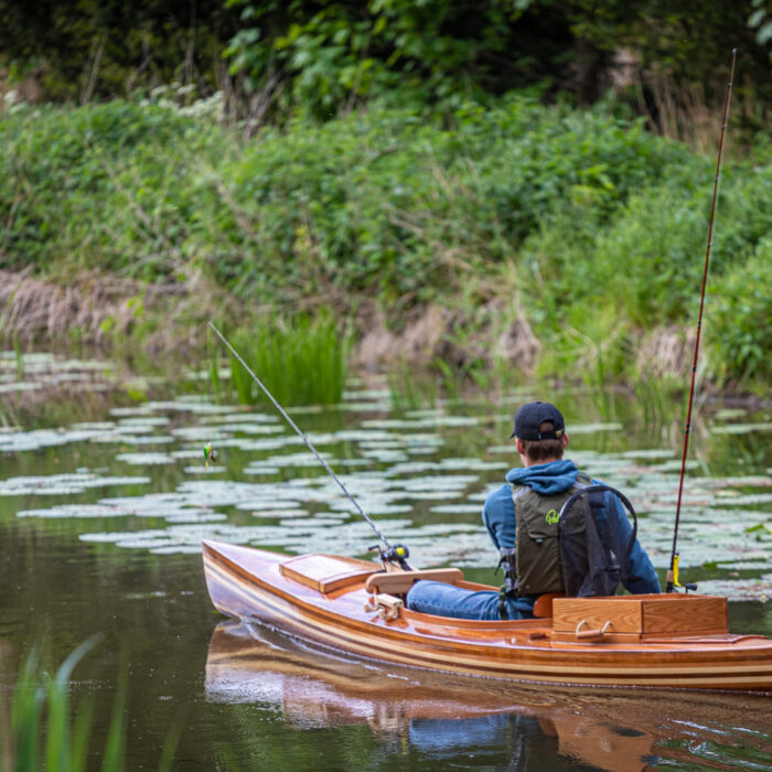 a wooden fishing canoe on the river
