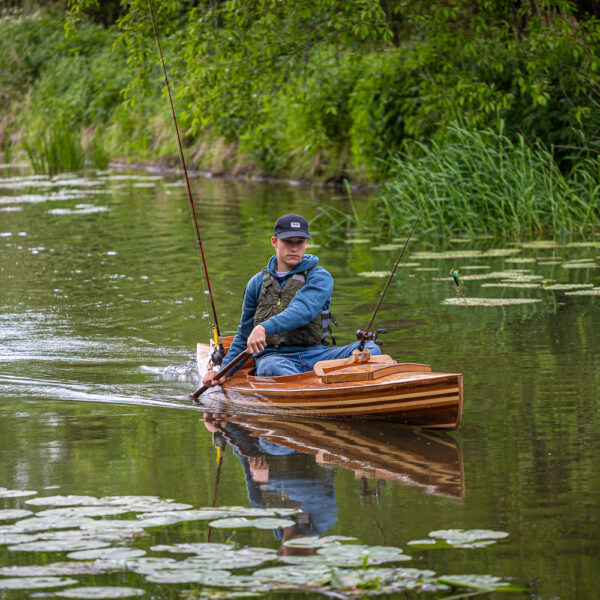 a wooden fishing canoe on the river